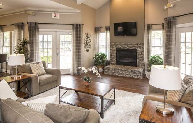 a living room with a fireplace and a tv on the wall