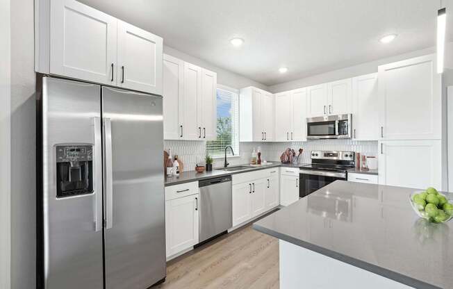 Model kitchen with stainless steel appliances and large kitchen island