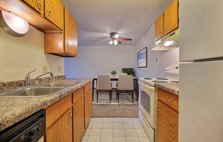 a kitchen with wooden cabinets and a dining room in the background at France, North Dakota, 58103