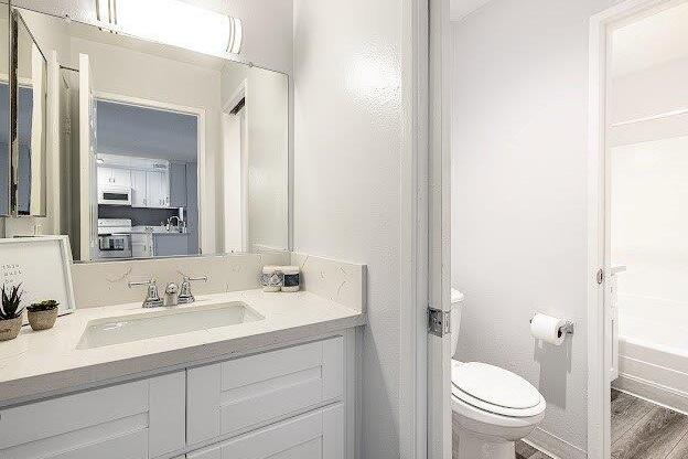 A white bathroom with a toilet and sink.