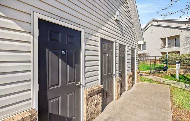 A row of houses with dark grey doors.