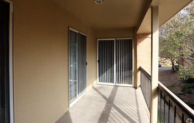 a balcony with a door and a patio