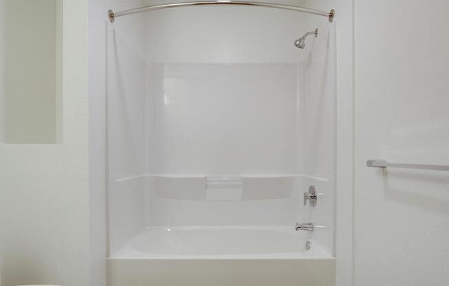 a white bath tub sitting next to a white toilet