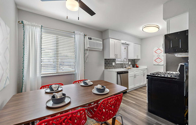 a kitchen and dining room with a wooden table and chairs