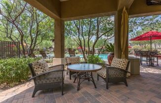 a patio with a table and chairs and a pool at Canyon Crossroads in Phoenix, AZ 85085