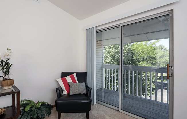 apartment living room with a sliding glass door to balcony