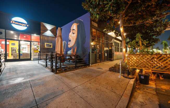 a mural of a woman on the side of a building at night