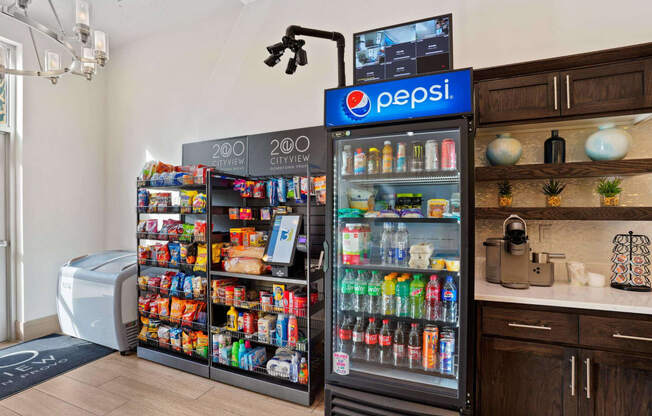 a cooler in a store with a refrigerator and a counter with drinks at 200 City View, Provo, Utah
