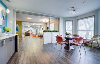 A modern kitchen with a dining table and chairs.