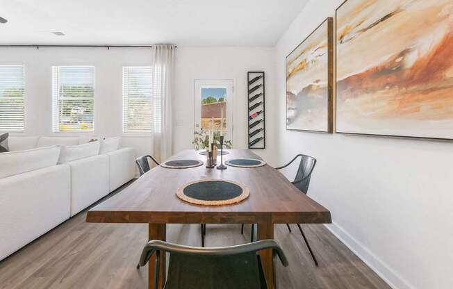 a dining room with a wooden table and chairs
