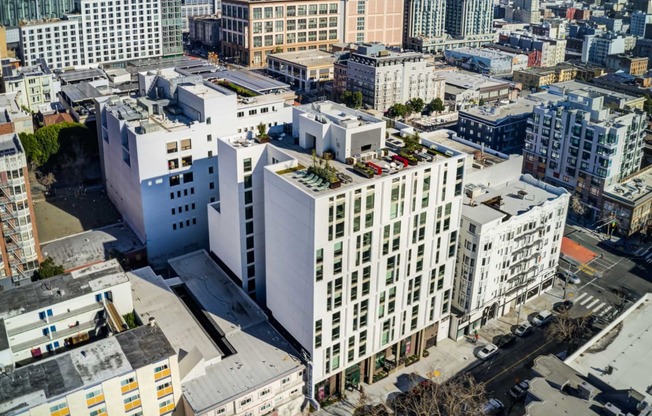 an aerial view of a large white building in the middle of a city