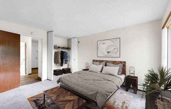 A bedroom with a large bed and a wooden floor.