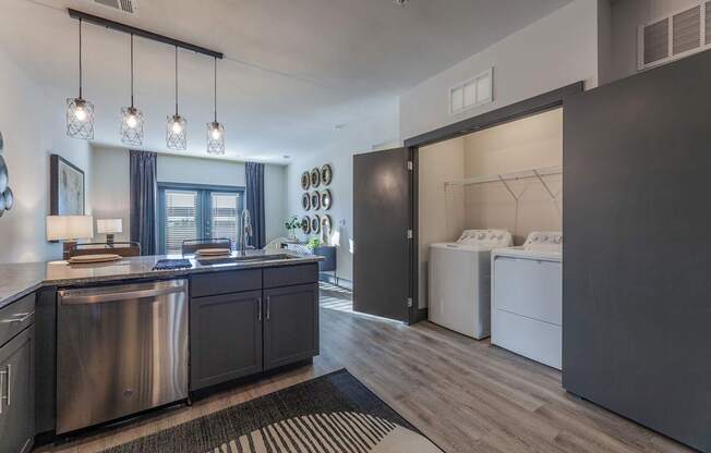 A modern kitchen with dark wood cabinets and stainless steel appliances.