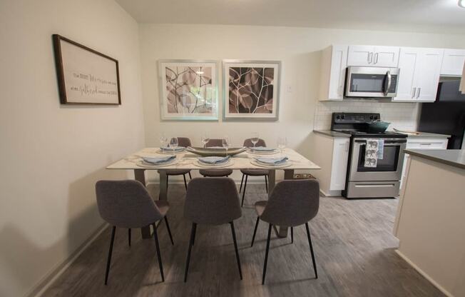 a kitchen and dining area with a table and chairs