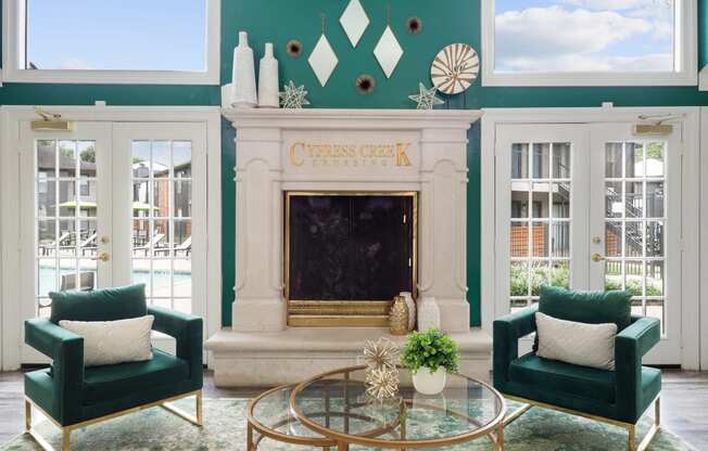 a living room with green walls and a fireplace