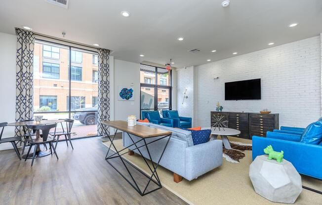 a living room filled with furniture and a large window