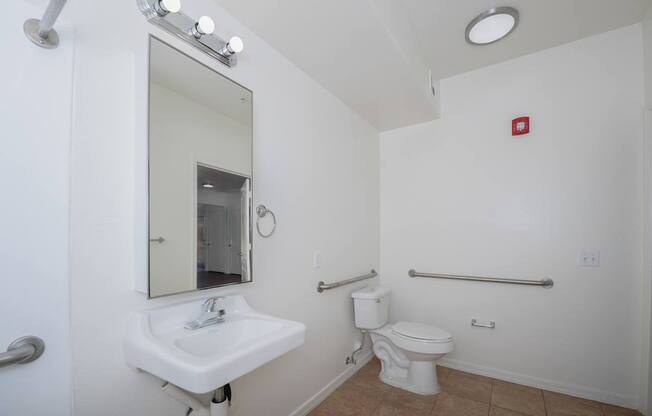 A white sink and toilet in a small bathroom.
