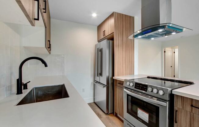 a kitchen with stainless steel appliances and a white counter top