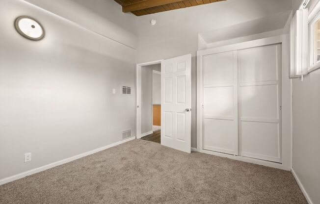 A room with a white door and a window.