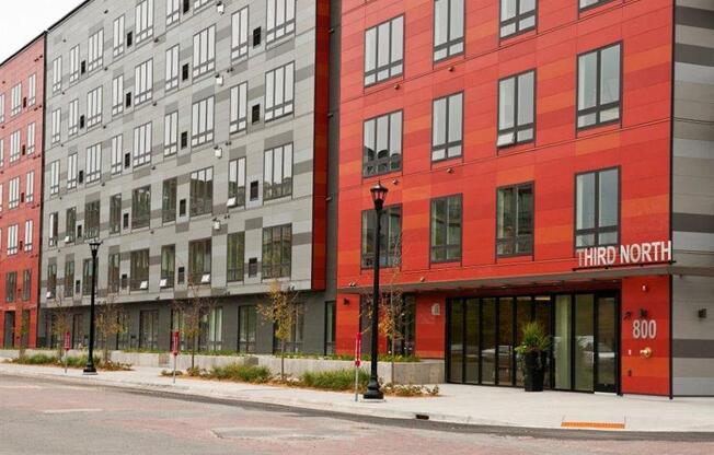 A street view of a red building with the words "Third North" on it.