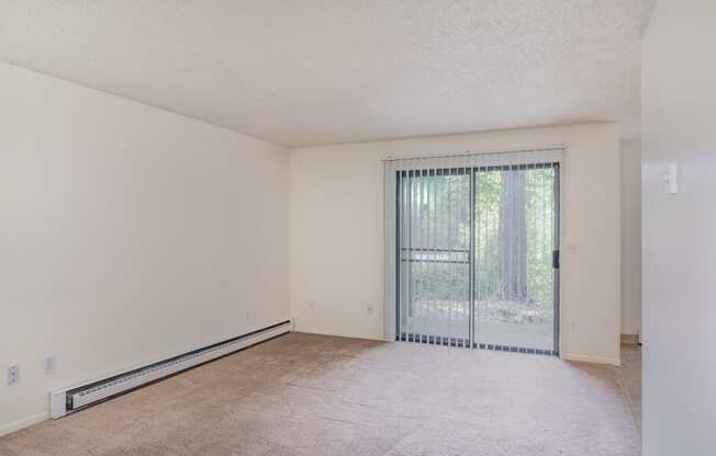 the spacious living room with sliding glass doors to the patio