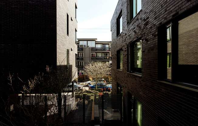 a view of a city street from an alley