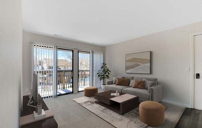 A living room with a grey couch, a brown ottoman, a coffee table, and a television.