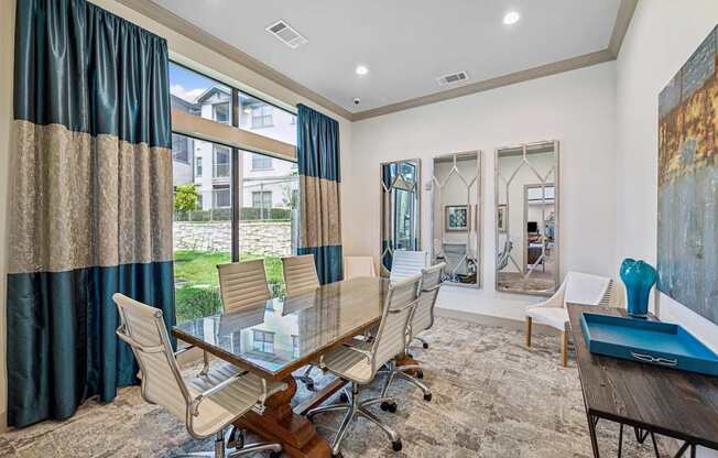A conference room with a long table and chairs.
