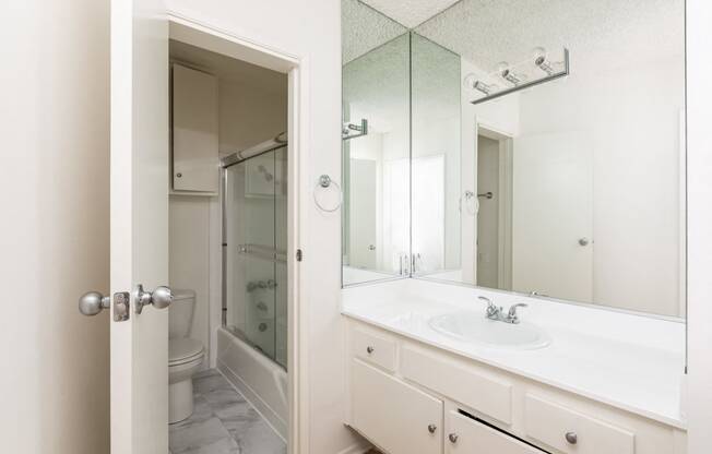 Bathroom with White Cabinets and Bathtub/Shower