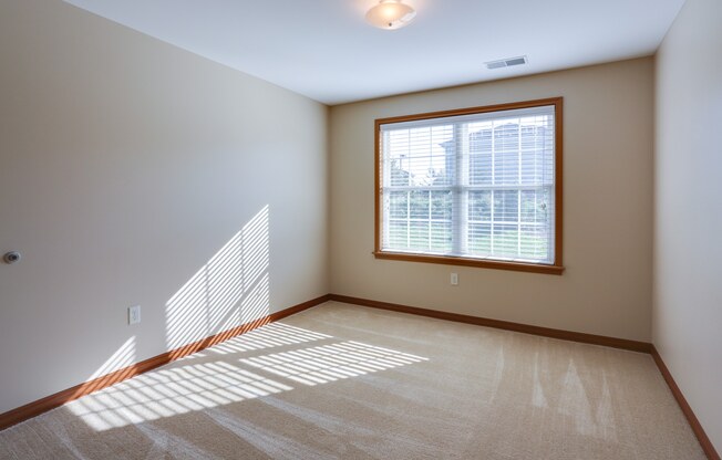 an empty living room with a large window