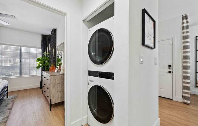 a front load washer and dryer in a laundry room