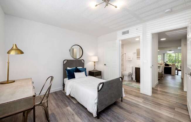 a bedroom with a bed and a desk