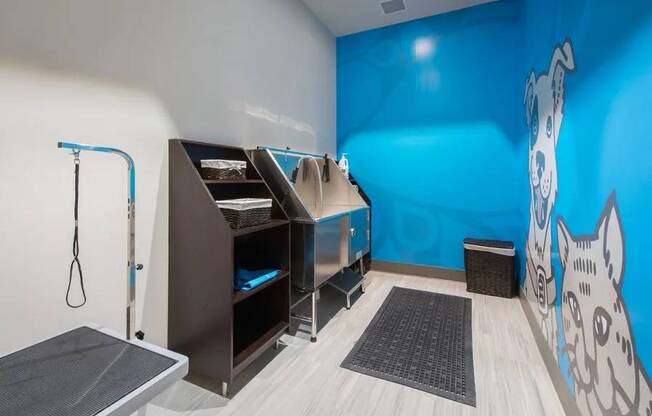 A room with a blue wall and a cat mural on it.