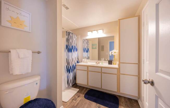 A bathroom with a white toilet and a white sink.