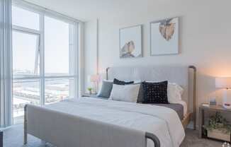 a bedroom with a large bed and a large window at Vue, Sand Pedro, CA 90731