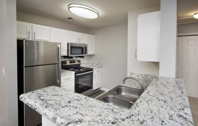 a kitchen with granite counter tops and stainless steel appliances