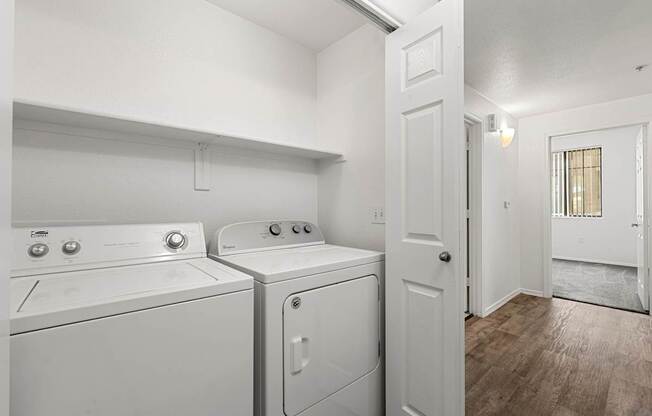 A small laundry room with a washer and dryer.