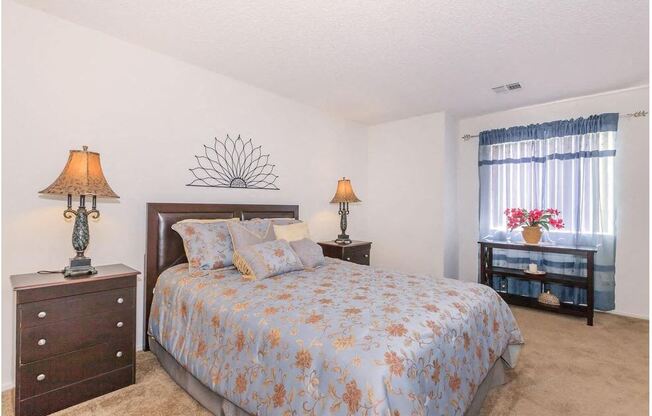 a bedroom with a bed and two dressers and a window at Riverview Springs, Oceanside, CA