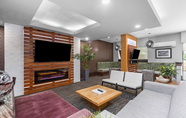 A modern living room with a fireplace and a flat screen TV.