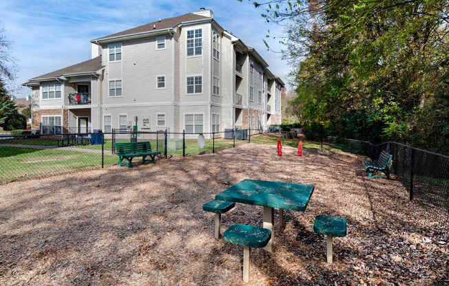 A large apartment complex with a playground in front.