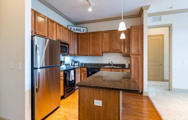 a kitchen with wooden cabinets and granite countertops