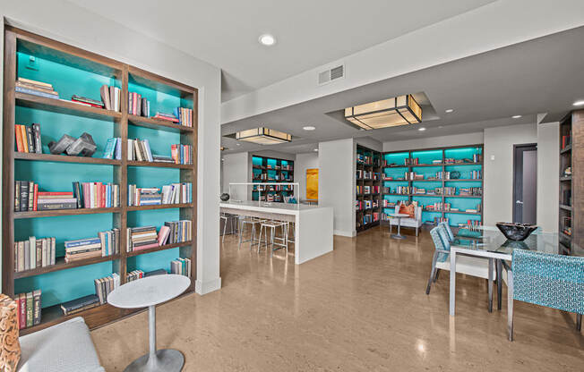 a library with tables and chairs and shelves of books