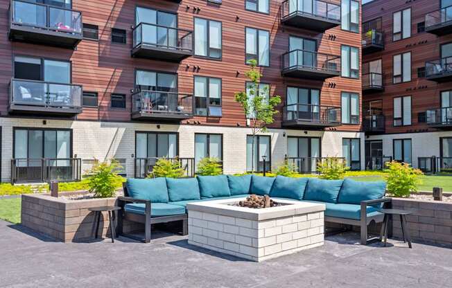 A modern apartment complex with a courtyard and seating area.
