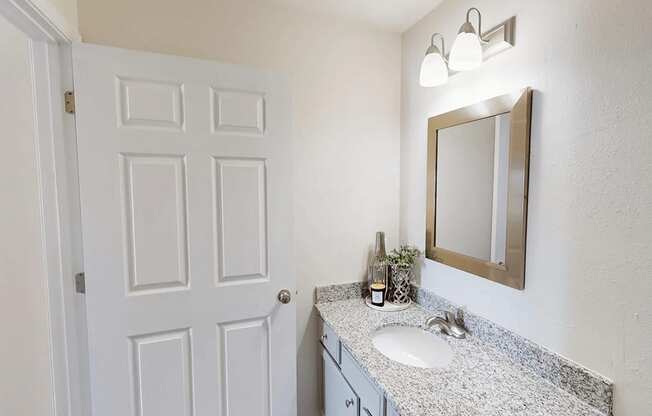 an empty bathroom with a sink and a mirror