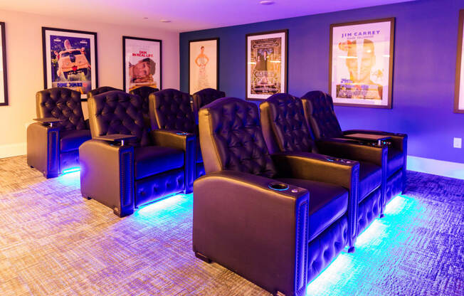 a room with blue chairs and purple lights