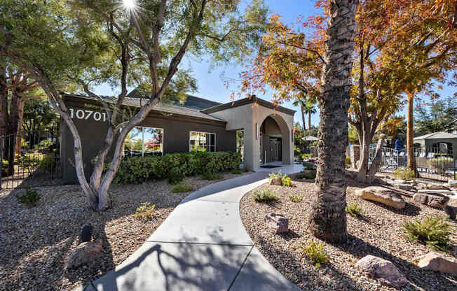 A house numbered 10701 is surrounded by trees and rocks.