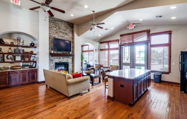 a living room with a fireplace and a kitchen