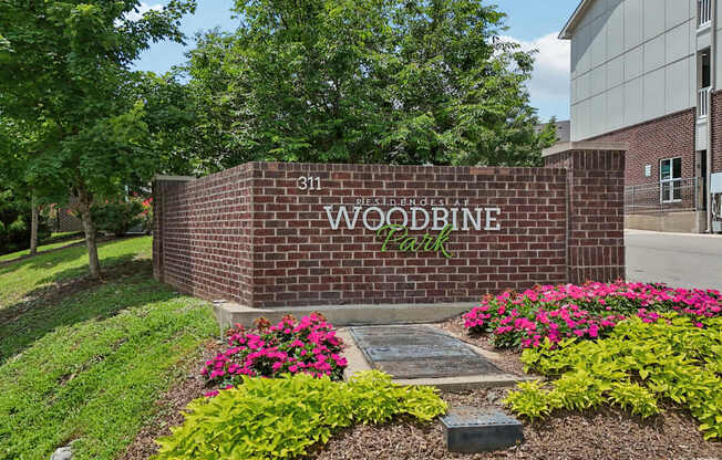 A brick wall with the words "Woodbine Park" on it.