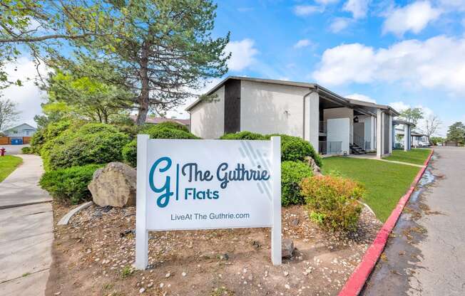 a sign for the gutter flats in front of a building