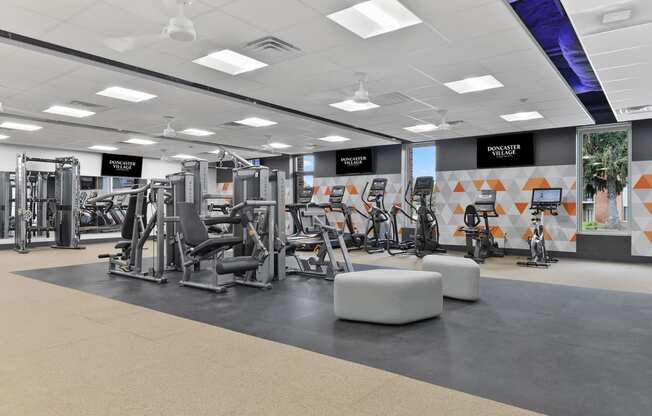 a gym with weights and other exercise equipment on the floor